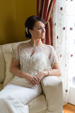 Bride Sitting in Chair by Window