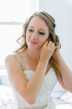 Bride putting on Jewelry