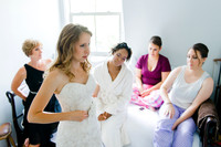 Bride getting into Wedding Gown