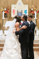 Father Kisses Bride at Alter