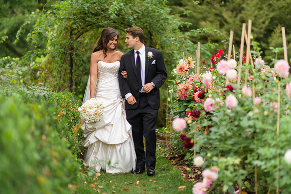 Bride and Groom walk in Garden